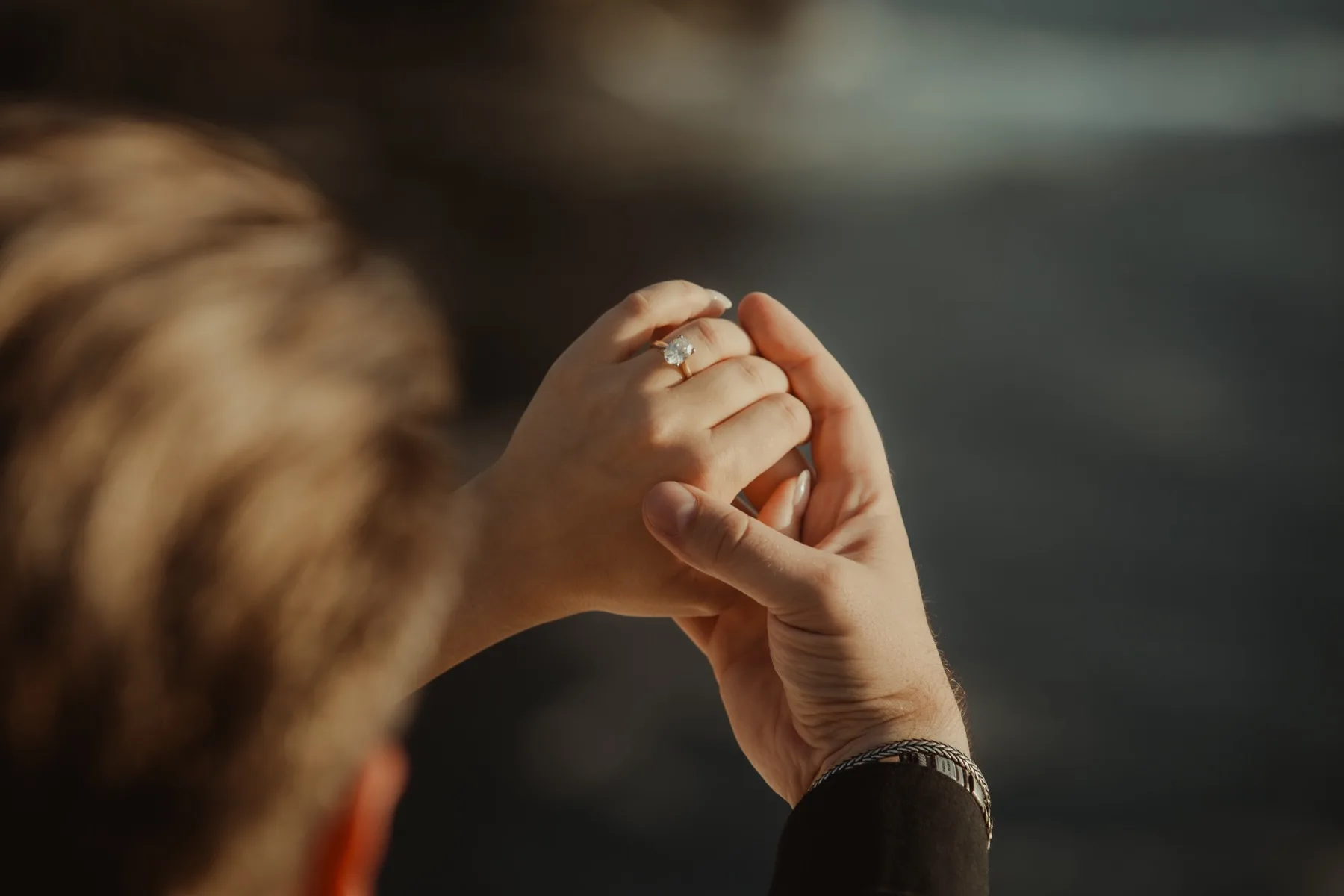 A close-up of Shannon and Oscar’s hands, her engagement ring catching the light